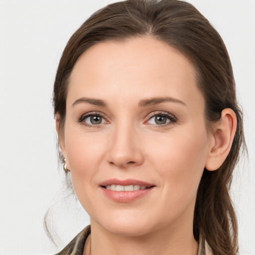 Joyful white young-adult female with medium  brown hair and grey eyes