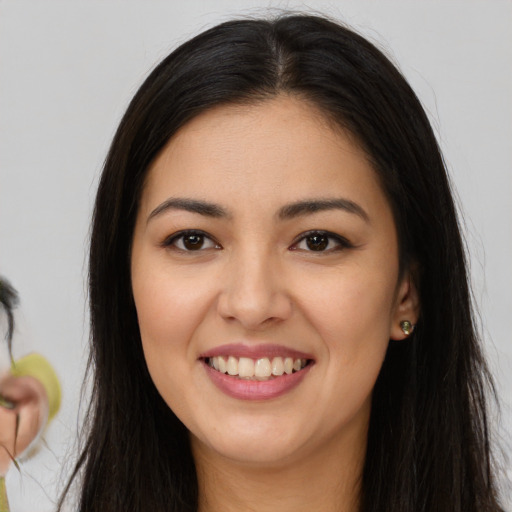 Joyful latino young-adult female with long  brown hair and brown eyes