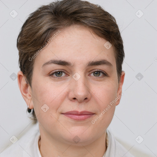 Joyful white young-adult female with short  brown hair and grey eyes