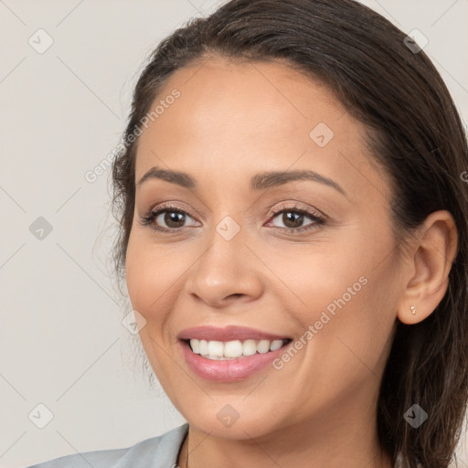 Joyful white young-adult female with long  brown hair and brown eyes