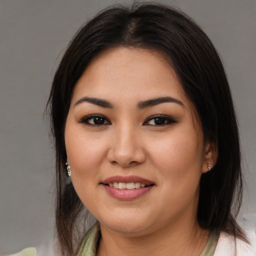 Joyful asian young-adult female with medium  brown hair and brown eyes