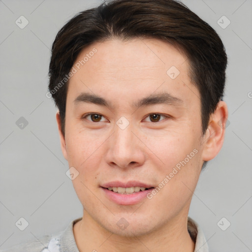 Joyful asian young-adult male with short  brown hair and brown eyes