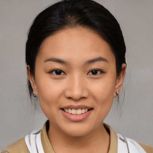 Joyful asian young-adult female with medium  brown hair and brown eyes