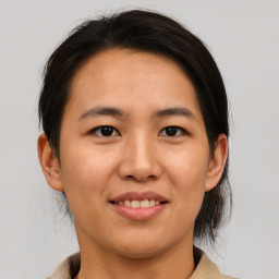 Joyful asian young-adult female with medium  brown hair and brown eyes