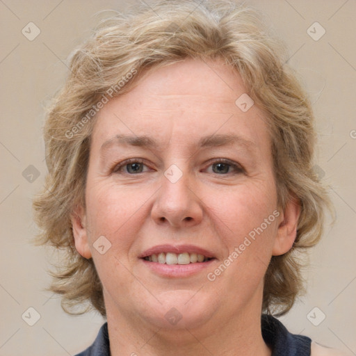 Joyful white adult female with medium  brown hair and blue eyes