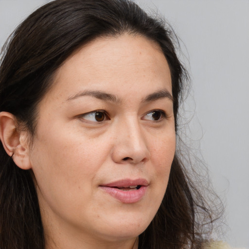 Joyful white adult female with long  brown hair and brown eyes