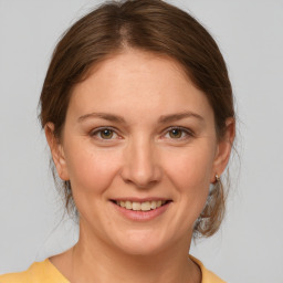 Joyful white adult female with medium  brown hair and brown eyes