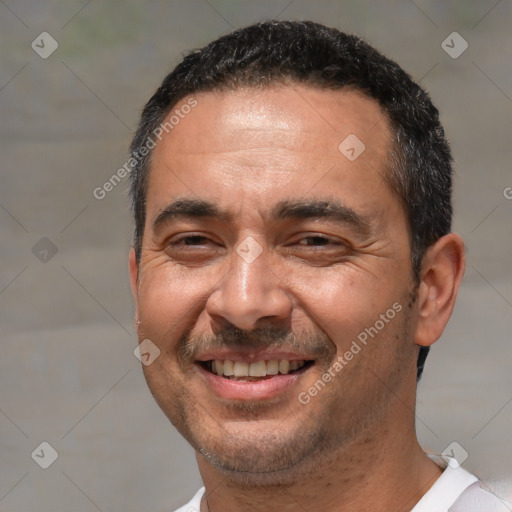 Joyful white adult male with short  black hair and brown eyes