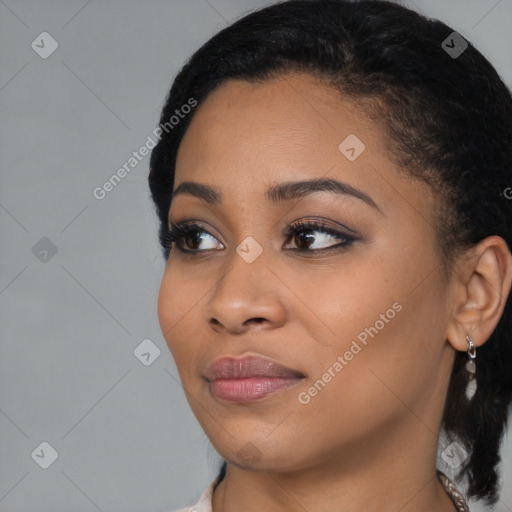 Joyful black young-adult female with medium  black hair and brown eyes