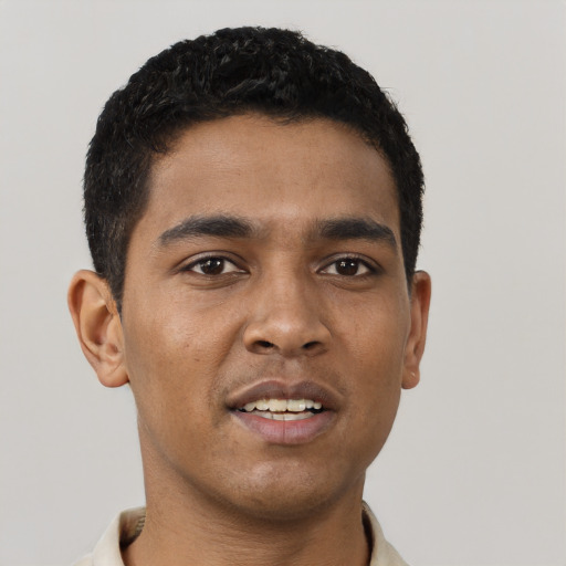 Joyful latino young-adult male with short  brown hair and brown eyes