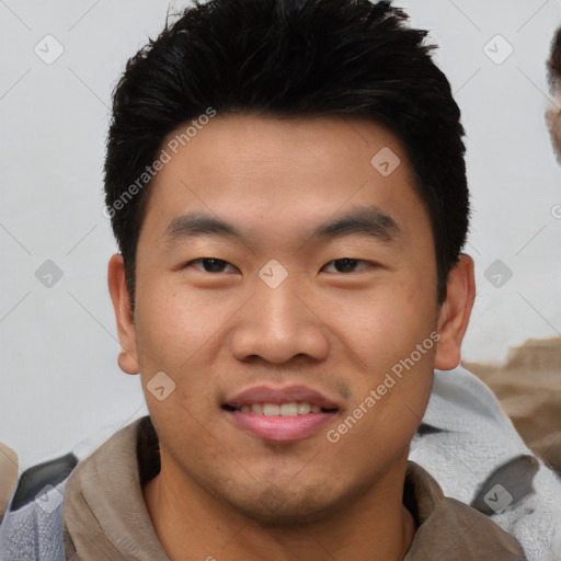 Joyful asian young-adult male with short  black hair and brown eyes