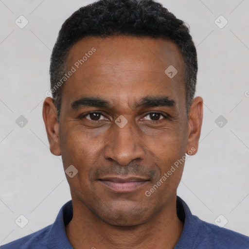 Joyful black adult male with short  black hair and brown eyes