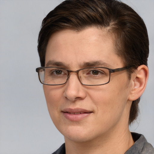 Joyful white adult female with short  brown hair and grey eyes