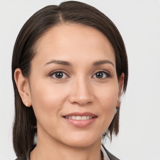 Joyful white young-adult female with medium  brown hair and brown eyes