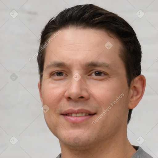 Joyful white adult male with short  brown hair and brown eyes