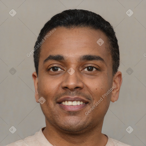 Joyful latino young-adult male with short  black hair and brown eyes