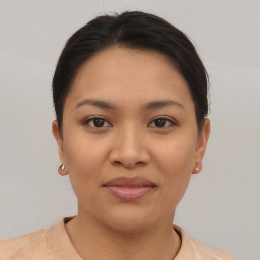 Joyful latino young-adult female with short  brown hair and brown eyes