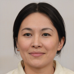 Joyful asian adult female with medium  brown hair and brown eyes