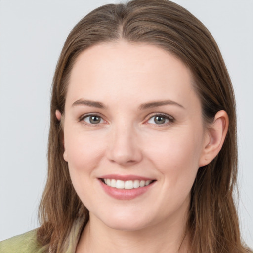 Joyful white young-adult female with long  brown hair and grey eyes