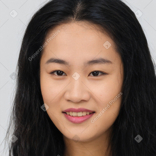 Joyful asian young-adult female with long  brown hair and brown eyes