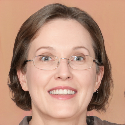 Joyful white adult female with medium  brown hair and blue eyes