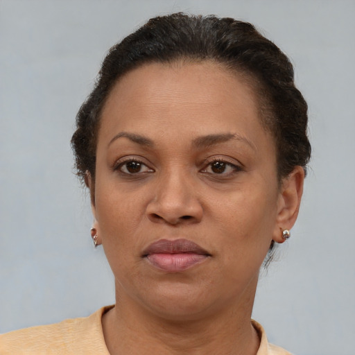 Joyful black adult female with short  brown hair and brown eyes