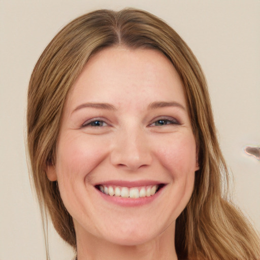 Joyful white adult female with long  brown hair and green eyes