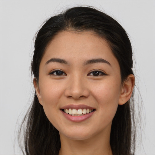 Joyful asian young-adult female with long  brown hair and brown eyes