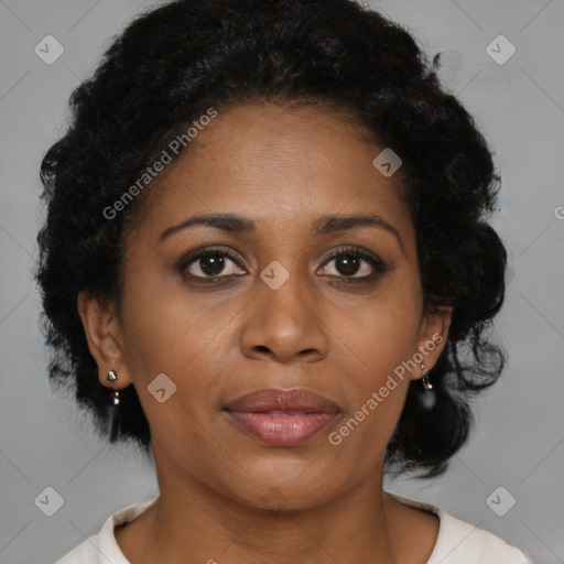 Joyful black adult female with medium  brown hair and brown eyes