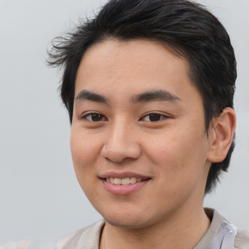 Joyful asian young-adult male with short  brown hair and brown eyes