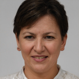 Joyful white adult female with short  brown hair and brown eyes