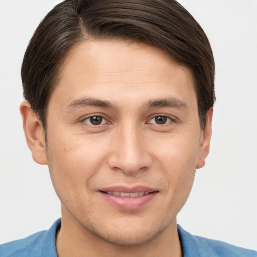 Joyful white young-adult male with short  brown hair and brown eyes