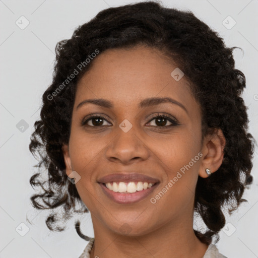 Joyful black young-adult female with medium  brown hair and brown eyes