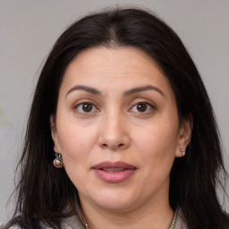 Joyful white adult female with long  brown hair and brown eyes