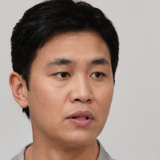 Neutral asian young-adult male with short  black hair and brown eyes