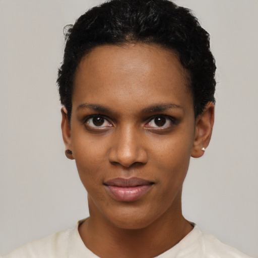 Joyful black young-adult female with short  black hair and brown eyes