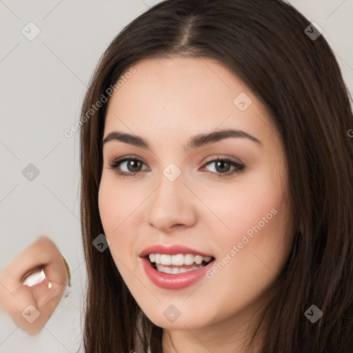 Joyful white young-adult female with long  brown hair and brown eyes