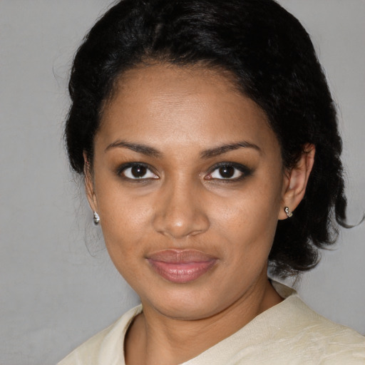 Joyful black young-adult female with short  black hair and brown eyes