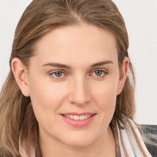 Joyful white young-adult female with long  brown hair and grey eyes