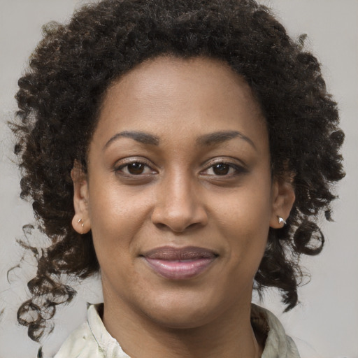Joyful black young-adult female with medium  brown hair and brown eyes