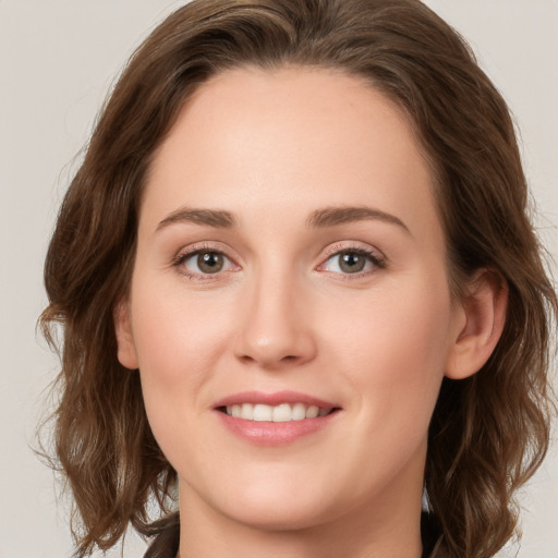 Joyful white young-adult female with medium  brown hair and green eyes