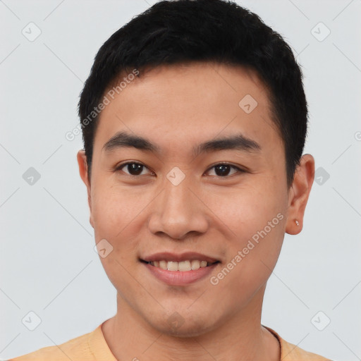 Joyful asian young-adult male with short  black hair and brown eyes