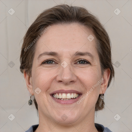 Joyful white adult female with medium  brown hair and grey eyes