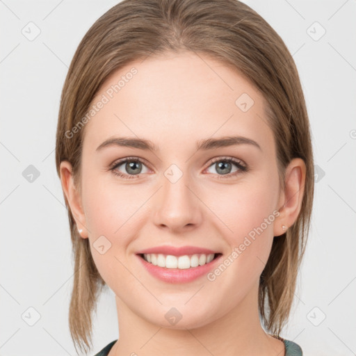 Joyful white young-adult female with medium  brown hair and blue eyes