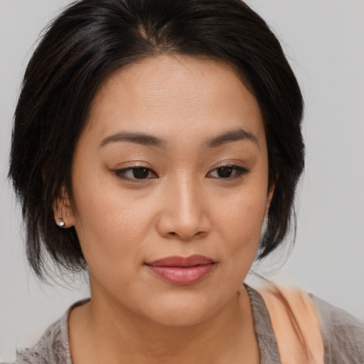 Joyful asian young-adult female with medium  brown hair and brown eyes