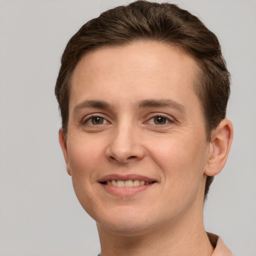 Joyful white young-adult female with short  brown hair and grey eyes