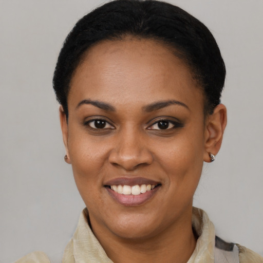 Joyful latino young-adult female with short  black hair and brown eyes