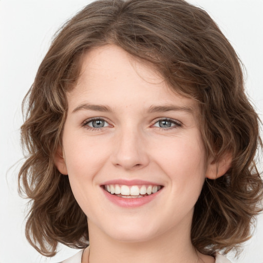 Joyful white young-adult female with medium  brown hair and green eyes