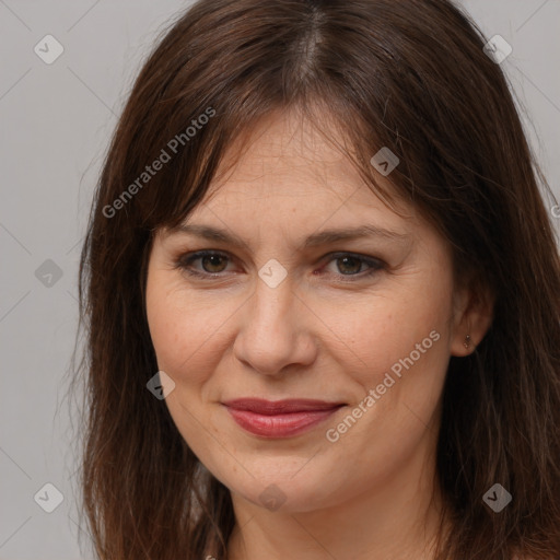 Joyful white adult female with long  brown hair and brown eyes