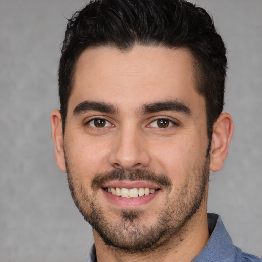 Joyful white young-adult male with short  black hair and brown eyes